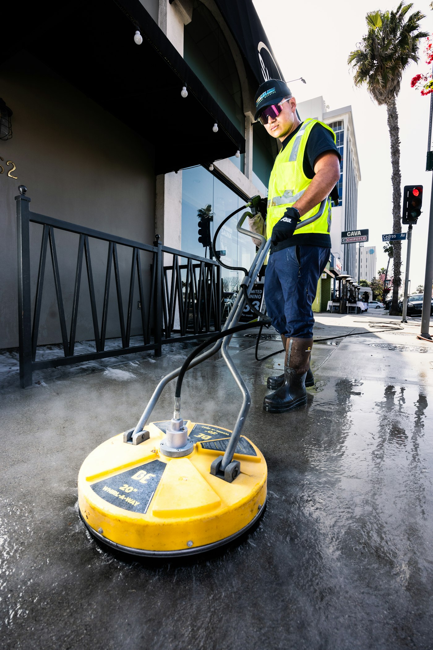 Pressure washing wand cleaning a concrete surface